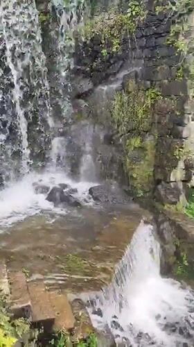 Tourists document cascading waterfalls and spring blooms in Ribeira Grande