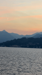 Sunset over Lake Como with crescent moon and mountain silhouettes
