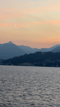 Sunset over Lake Como with crescent moon and mountain silhouettes