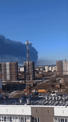 Smoke rises over urban area near communications tower