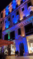 Evening pedestrian activity captured on illuminated Budapest street