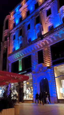 Evening pedestrian activity captured on illuminated Budapest street