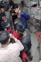 Teen group gathers in Dhaka alley near political posters