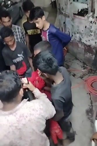 Teen group gathers in Dhaka alley near political posters