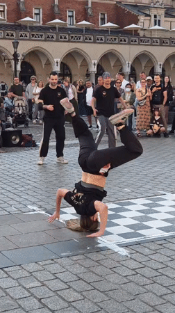Breakdancers and street performers draw a crowd in Kraków