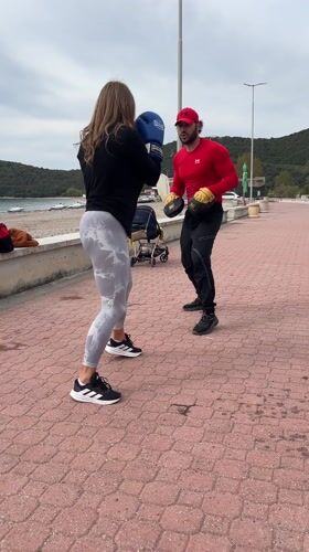 Woman practices boxing on seaside promenade in Montenegro