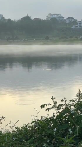 Early morning activity along Da Lat's misty lakeside path
