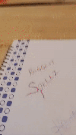 Handwritten notebook reading 'BIGGEST SPELLZ' in Bukuru, Nigeria