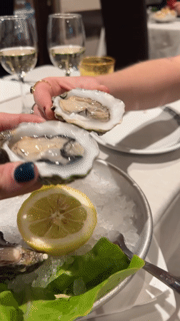 Woman dines on oysters at Milan restaurant