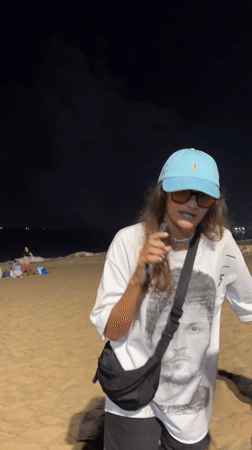 Evening beach gathering and night market activity in Nha Trang