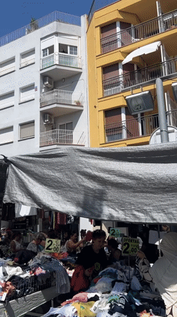 Street market and graffiti murals fill Mollet del Vallès on a summer morning