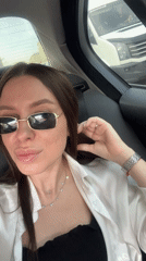 Woman takes selfies in car during Moscow traffic