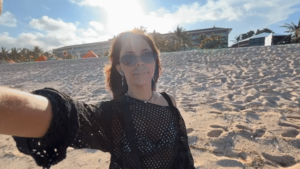 Woman documents beach morning stroll in Kuta Selatan