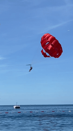Morning beach recreation and parasailing documented in Budva Montenegro