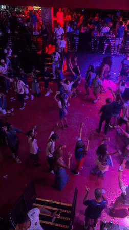 Late-night Fort Lauderdale club crowd fills the floor under DJ set