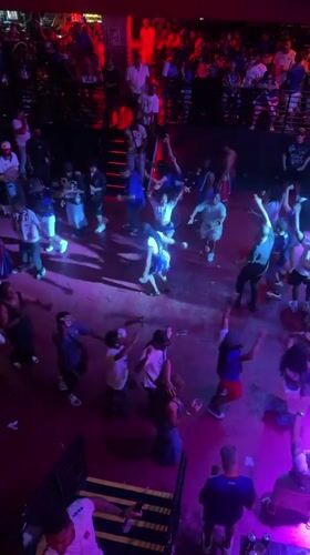 Late-night Fort Lauderdale club crowd fills the floor under DJ set