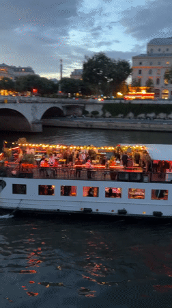Evening river cruise and street life documented along Paris Seine