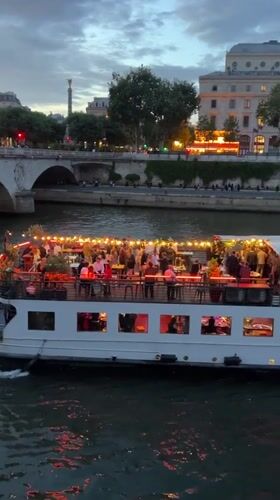 Evening river cruise and street life documented along Paris Seine