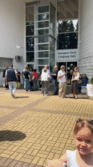 People gather outside Congress Hall in Sochi