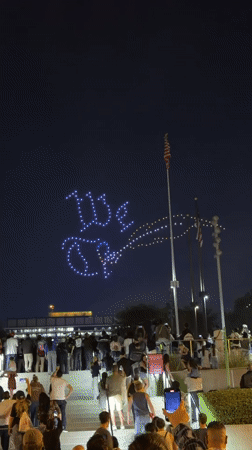 Drone light show spells patriotic phrases over LA crowd at night