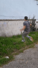Man climbs over ivy-covered wall in Svishtov, Bulgaria