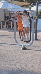 Afternoon at Málaga's beachfront: sand, swings, and a modern bridge