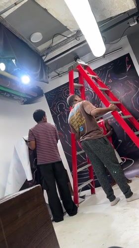 Men install wall covering at Ikeja workshop