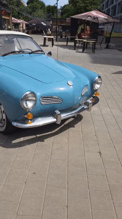 Classic Karmann Ghia parked on a Minsk cobblestone plaza
