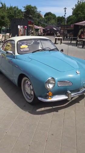 Classic Karmann Ghia parked on a Minsk cobblestone plaza