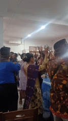 Indoor celebration with dancing and cash in Babelan, Indonesia
