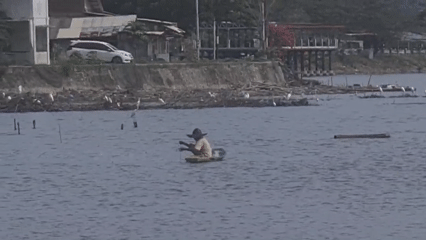 Person fishing from small boat in Lhokseumawe waters