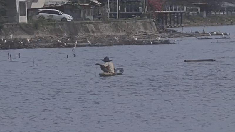Person fishing from small boat in Lhokseumawe waters