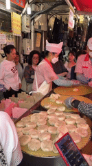 Seoul market vendors serve dumplings to early morning customers