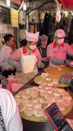 Seoul market vendors serve dumplings to early morning customers