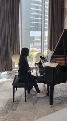 Woman plays piano in Burnaby urban plaza
