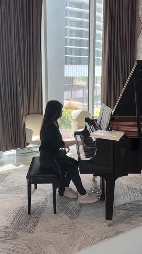 Woman plays piano in Burnaby urban plaza