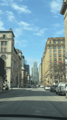Vehicle passenger captures Montreal street view with historic buildings