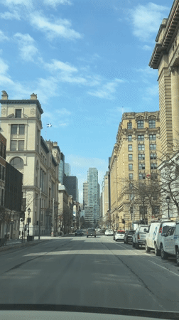 Vehicle passenger captures Montreal street view with historic buildings