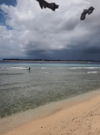 Tourist documents Indonesian beachfront bar with ocean views