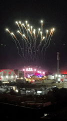 Fireworks and street crowds at a late-night event in Loures