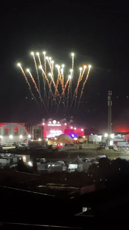 Fireworks and street crowds at a late-night event in Loures