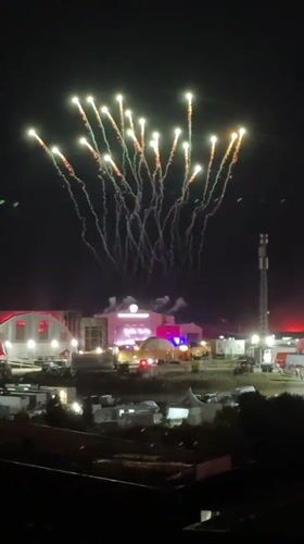 Fireworks and street crowds at a late-night event in Loures