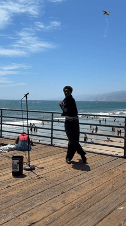 Live street performance on the Santa Monica Pier, July evening.