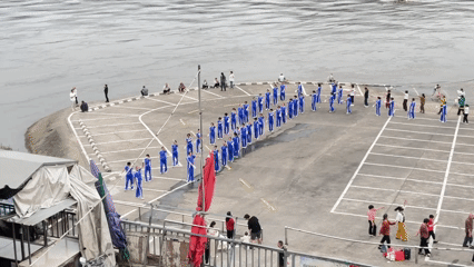 Daily life unfolds in Jiangjin as groups exercise by river
