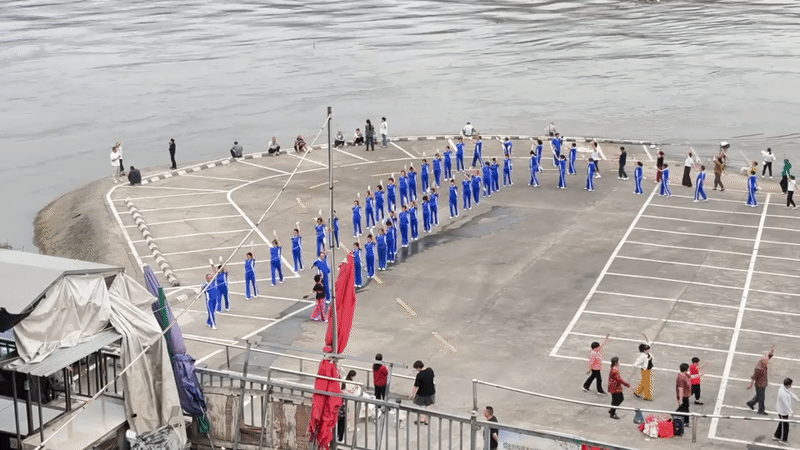 Daily life unfolds in Jiangjin as groups exercise by river