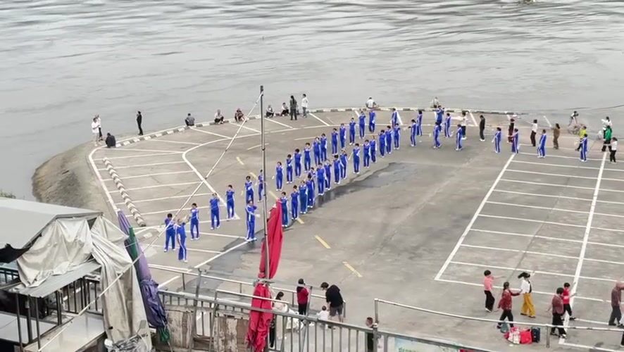 Daily life unfolds in Jiangjin as groups exercise by river