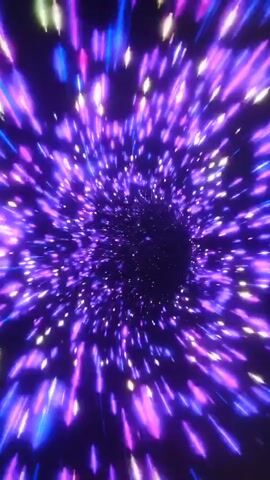The video shows a point-of-view shot of traveling through a colorful wormhole or tunnel. Streaks of light in various colors, including purple, pink, red, orange, and green, rush towards the viewer and then disappear into a dark center. The lights appear to be moving at a high speed, creating a sense of motion and depth. The background is dark, emphasizing the bright, vibrant colors of the light streaks. There are no people or recognizable objects in the video, only abstract light patterns. The overall impression is one of rapid movement through a cosmic or digital space.