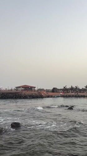 Early morning fishing activity captured on weathered Jeddah pier