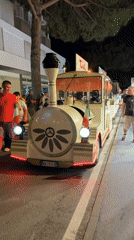 Novelty tourist train parked on a Gatteo street at night