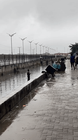 Rainy morning deliveries and construction traffic in Igboefon, Lagos